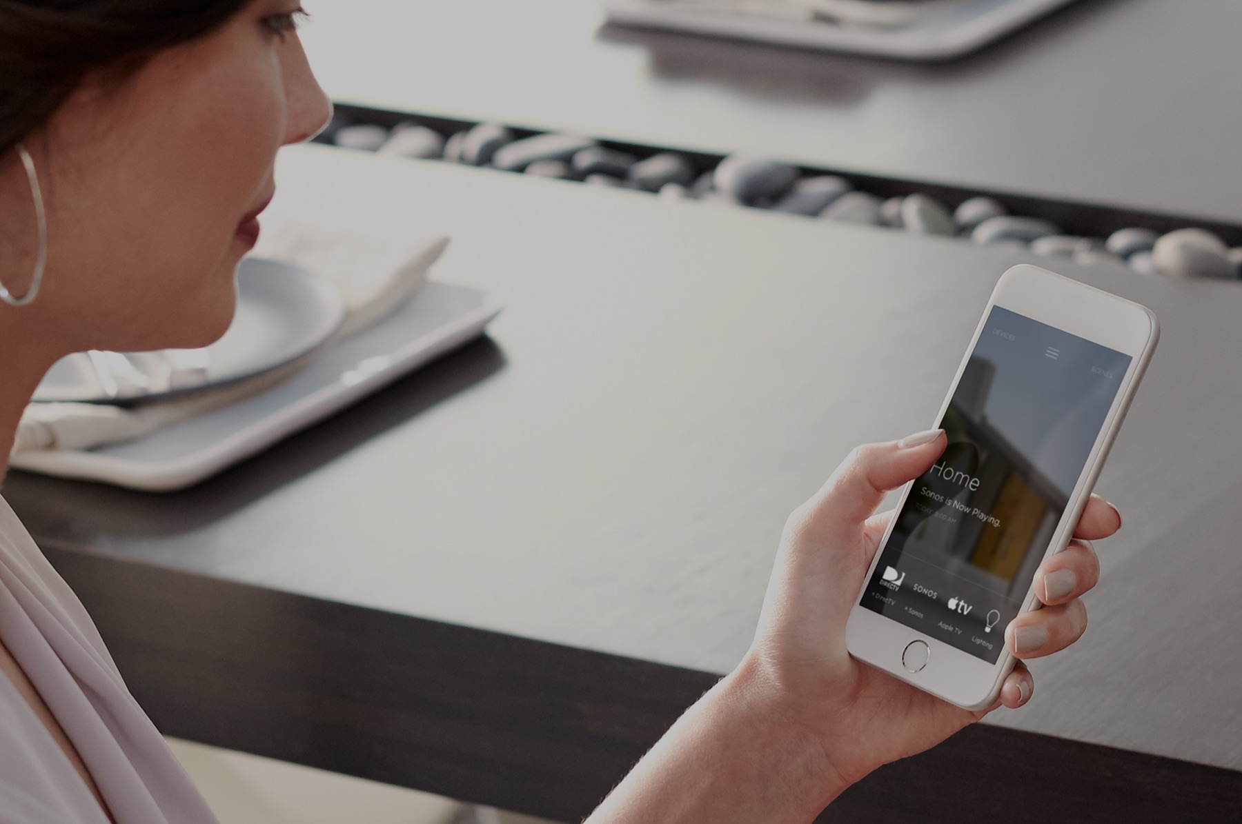 Hand holding a phone running a home control app