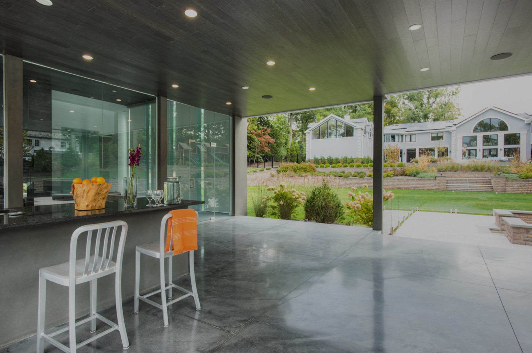 Covered outdoor bar overlooking a landscaped yard